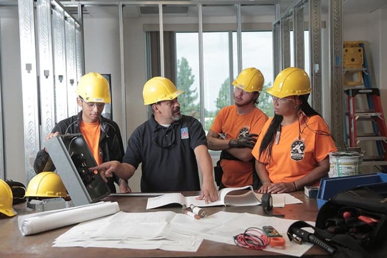 Construction workers looking over blueprints