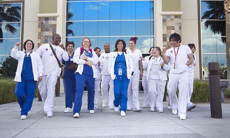 A group of Summit College nursing and medical assisting students exiting the Colton campus building.